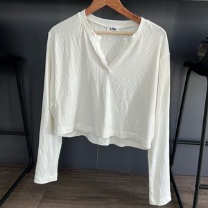 LNA cropped white long sleeve top.
